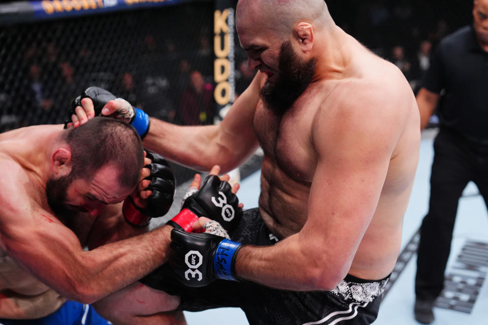 LAS VEGAS, NEVADA - DECEMBER 16: (R-L) Shamil Gaziev of Russia knees Martin Buday of Slovakia in a heavyweight fight during the UFC 296 event at T-Mobile Arena on December 16, 2023 in Las Vegas, Nevada. (Photo by Jeff Bottari/Zuffa LLC via Getty Images)