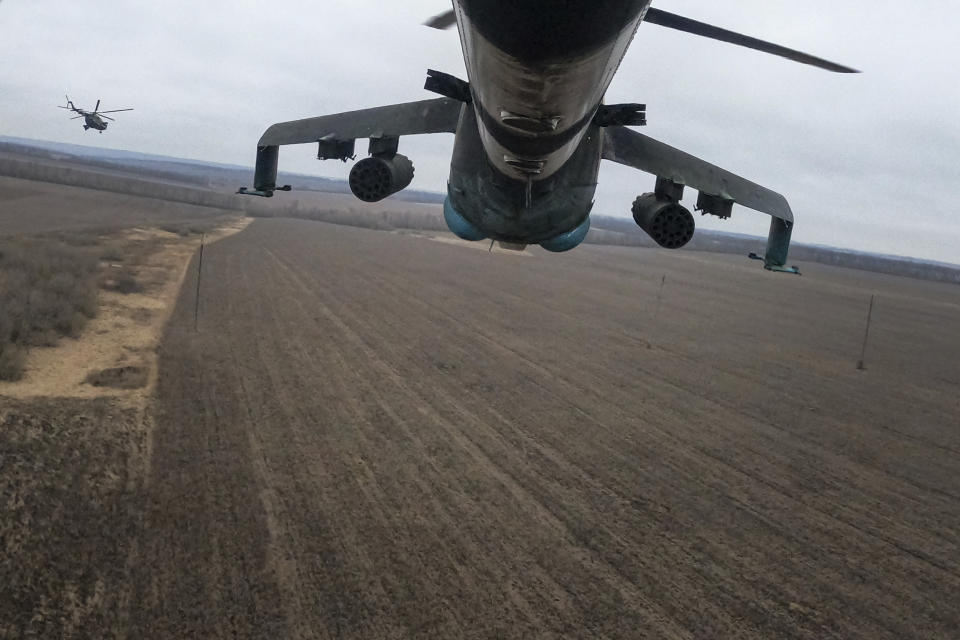 Ukrainian Mi-24 and Mi-8 helicopters fly towards Russian positions during a combat mission in Donetsk region, Ukraine, Sunday, March 19, 2023. (AP Photo/Evgeniy Maloletka)