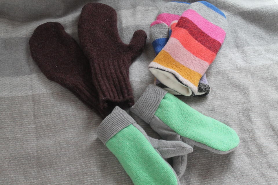 This Feb. 4, 2020 photo taken in Hopkinton, N.H., shows three pairs of handmade mittens, each constructed from sweaters using slightly different techniques. If winter is lasting longer than the groundhog predicted where you live, consider restocking your mitten supply and clearing out your closet at the same time. Instead of tossing stained or accidentally shrunken sweaters, turn them into cozy mittens. (AP Photo/Holly Ramer)