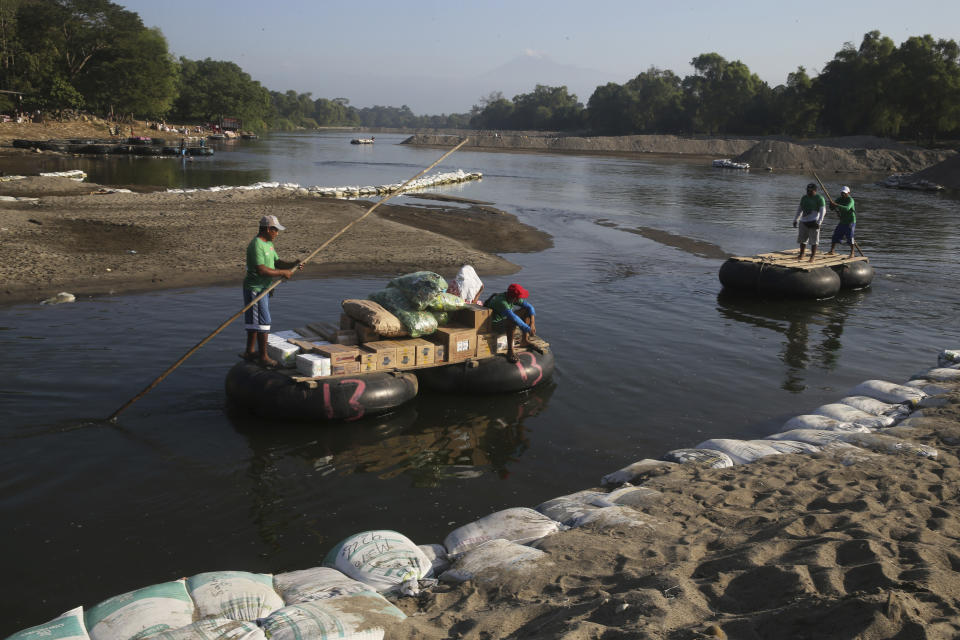 Locals transport food across the Suchiate River from Mexico to Guatemala, as they move away from Ciudad Hidalgo, Mexico, Wednesday, Jan. 22, 2020, a location popular for migrants to cross from Guatemala to Mexico. Mexico announced last June that it was deploying the newly formed National Guard to assist in immigration enforcement to avoid tariffs that Trump threatened on Mexican imports. (AP Photo/Marco Ugarte)