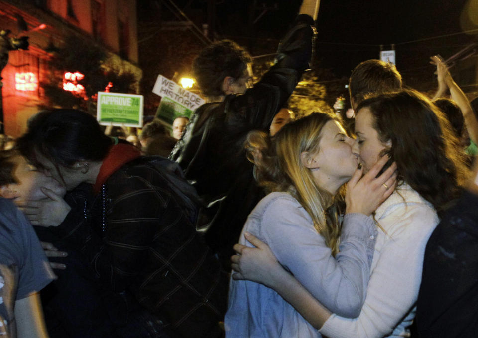 Revelers kiss as they celebrate early election returns favoring Washington state Referendum 74, which would legalize gay marriage, during a large impromptu street gathering in Seattle's Capitol Hill neighborhood, in the early hours of Wednesday, Nov. 7, 2012. The re-election of President Barack Obama and Referendum 74 drew the most supporters to the streets. (AP Photo/Ted S. Warren)