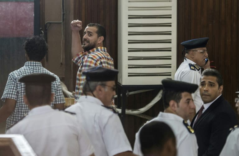 Al-Jazeera journalists, Canadian Mohamed Fahmy (R) and Egyptian Baher Mohamed (C), attend their trial in the capital Cairo on August 29, 2015