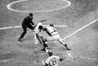 FILE - Lou Brock of the St. Louis Cardinals is tagged out at home plate by Detroit Tigers catcher Bill Freehan in the fifth inning of World Series Game 5 at Tiger stadium in Detroit, in this Monday, Oct. 7, 1968, file photo. Watching is umpire Doug Harvey who made the call. Freehan, an 11-time All-Star catcher with the Detroit Tigers and key player on the 1968 World Series championship team, has died at age 79. "It's with a heavy heart that all of us with the Detroit Tigers extend our condolences to the friends and family of Bill Freehan," the team said Thursday, Aug. 19, 2021. (AP Photo/File)