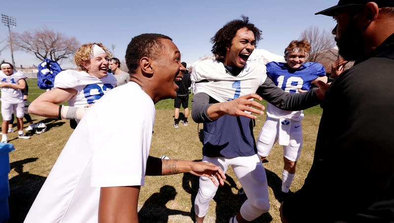 Wide receiver Parker Kingston, cornerback Zion Allen, wide receiver Keanu Hill, and quarterback Ryder Burton laugh as they talk with cornerbacks coach Jernaro Gilford after the Cougars football practiced in Provo on Friday, March 17, 2023.