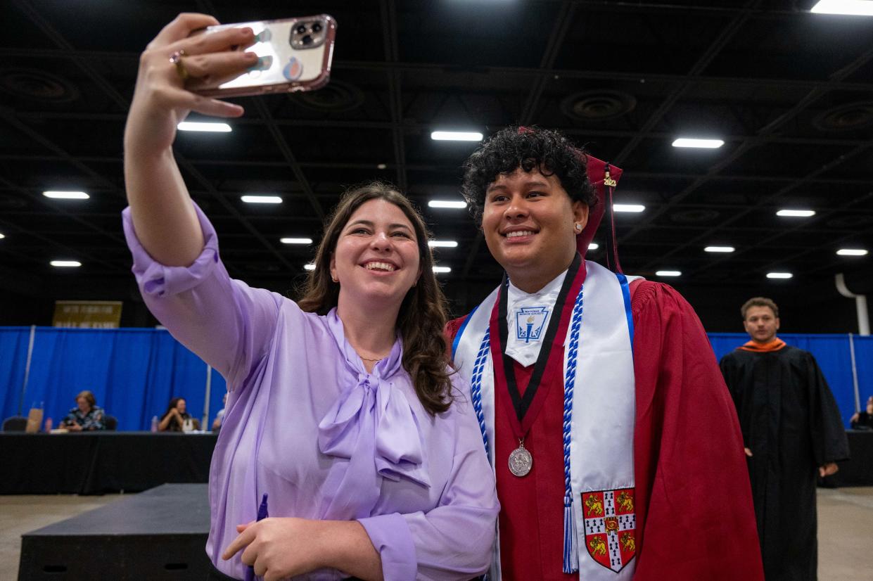 Celine Besman, an Avid teacher at Palm Beach Central, takes a selfie with her student, graduating senior Gabriel Eduardo Palma, before the start of the Palm Beach Central Class of 2023 high school graduation ceremony on Wednesday, May 17, 2023, at the South Florida Fair in West Palm Beach, Fla.