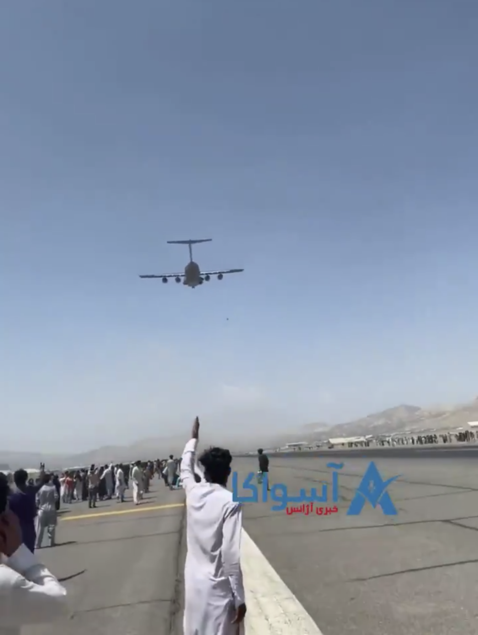 Person falls to their death from airborne C-17 plane, which they had clung to as it departed from the Kabul, Afghanistan, airport