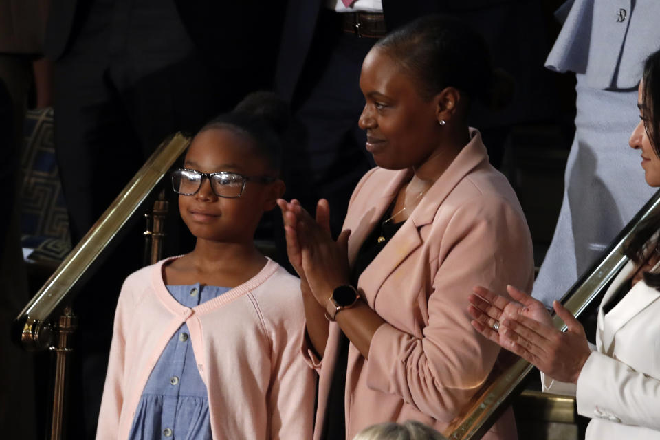 Janiyah, left, and Stephanie Davis of Philadelphia, listen as President Donald Trump delivers his State of the Union address to a joint session of Congress on Capitol Hill in Washington, Tuesday, Feb. 4, 2020. (AP Photo/Alex Brandon)