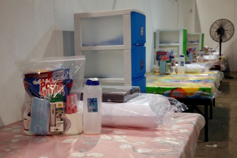 A bag of toiletries, thermometer, hand sanitiser and other essentials are left on beds at Changi Exhibition Centre which has been repurposed into a community isolation facility, in Singapore