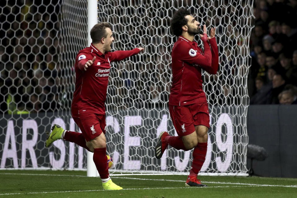 Liverpool's Mohamed Salah, right, celebrates scoring his side's first goal of the game with team mate Xherdan Shaqiri during their English Premier League soccer match against Watford at Vicarage Road, Watford, England, Saturday, Nov. 24, 2018. (Chris Radburn/PA via AP)