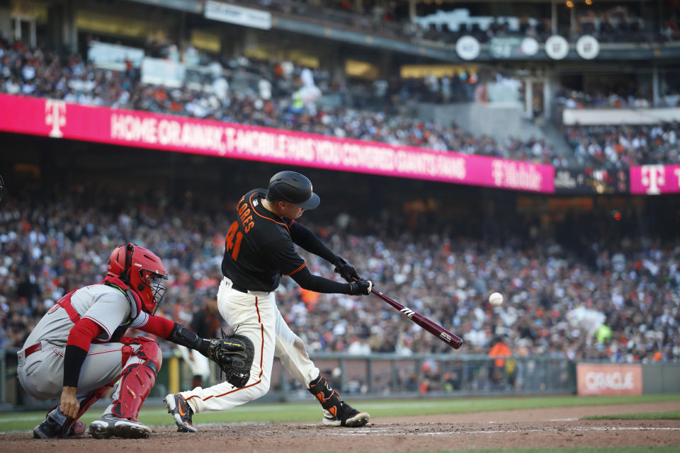 San Francisco Giants' Wilmer Flores (41) hits a three-run home run against the Cincinnati Reds during the sixth inning of a baseball game in San Francisco, Saturday, June 25, 2022. (AP Photo/Josie Lepe)