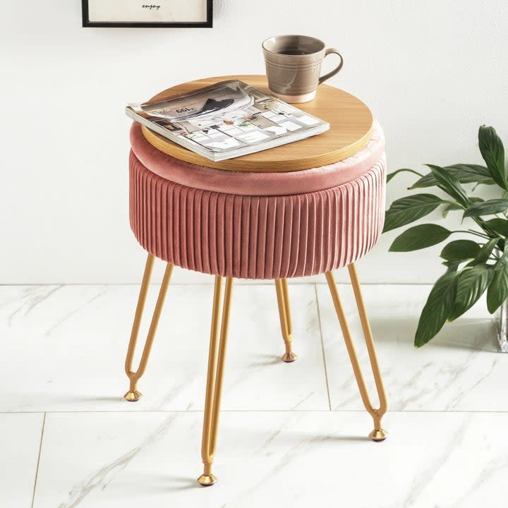 The storage ottoman with a mug and magazine on top