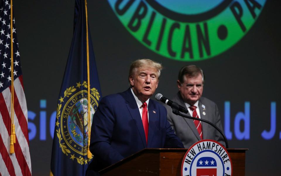 Donald Trump speaks as outgoing chairman of the New Hampshire Republican Party Stephen Stepanek looks on during the New Hampshire Republican State Committee annual meeting - AP