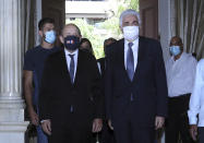 Lebanese Foreign Minister Nassif Hitti, right, receives his French counterpart Jean-Yves Le Drian at the Lebanese Foreign Ministry in Beirut, Lebanon, Thursday, July. 23, 2020. Le Drian met with Lebanon's president Thursday at the start of his two-day visit to the Mediterranean country that is witnessing the worst economic crisis of its modern history. (AP Photo/Bilal Hussein)