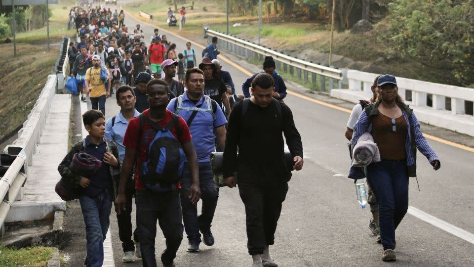 Migrants walk in a caravan in an attempt to reach the US border, in Escuintla, Mexico, on December 27. - Jose Torres/Reuters