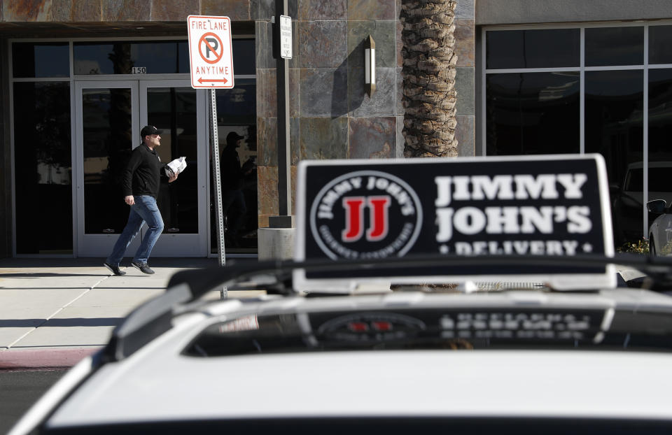 FILE - In this Feb. 6, 2019, photo, Tyler Schwecke, a delivery driver for Jimmy John's, makes a delivery in Las Vegas. Despite pressure from third-party apps, a few big chains continue to use their own drivers, and they’re hiring. (AP Photo/John Locher, File)