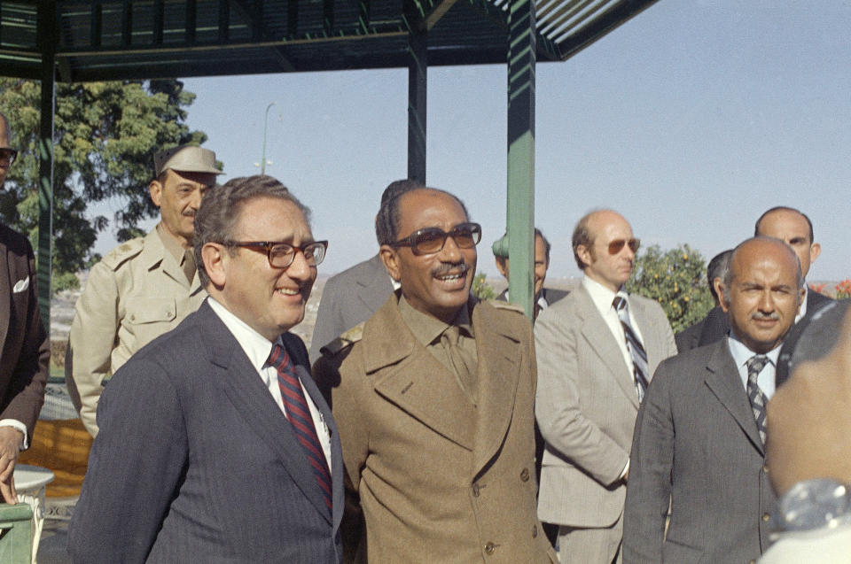 FILE - U.S. Secretary of State Henry Kissinger, left, and Egypt's President Anwar Sadat in Cairo, Egypt, Jan. 16, 1974. Henry Kissinger's legacy in the Mideast is the pursuit of what's possible, not necessarily peace, in one of the world's most intractable conflicts. The former U.S. secretary of state, who died this week at age 100, did just that after Egypt and Syria pulled of a surprise invasion of Israel 50 years ago. (AP Photo/Ahmed el Tayeb)