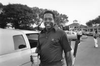 FILE - Lee Elder is seen arriving at the Masters golf course to play practice round in Augusta, Ga., on April 10, 1975. Elder broke down racial barriers as the first Black golfer to play in the Masters and paved the way for Tiger Woods and others to follow. The PGA Tour confirmed Elder’s death, which was first reported by Debert Cook of African American Golfers Digest. No cause or details were immediately available, but the tour said it spoke with Elder's family. He was 87. (AP Photo/File)