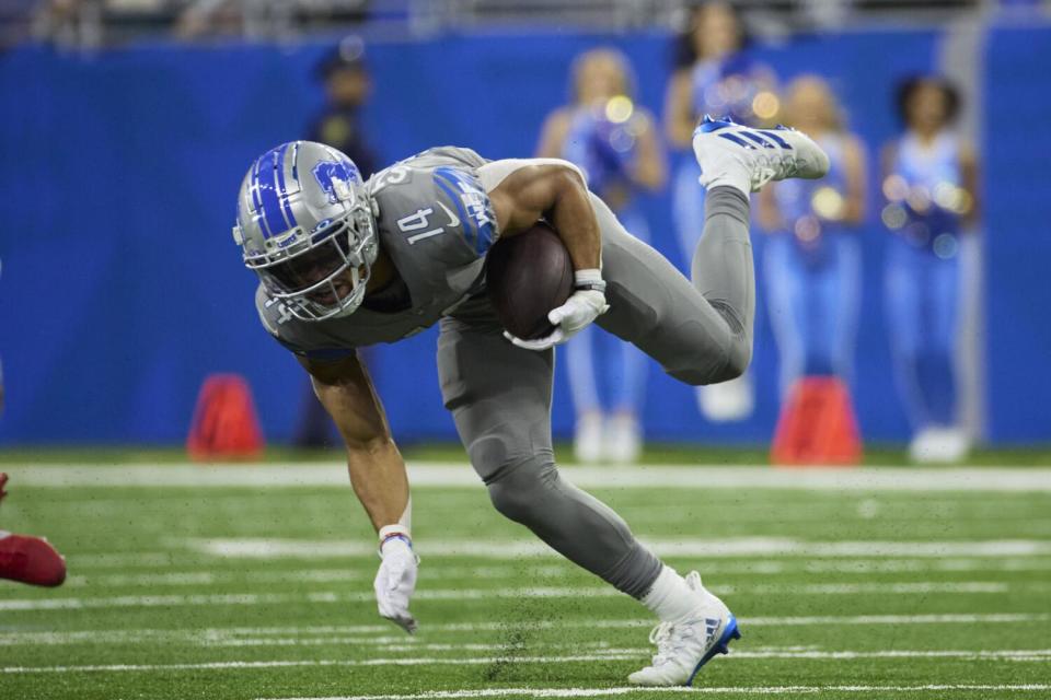 Detroit Lions wide receiver Amon-Ra St. Brown (14) runs after a catch.