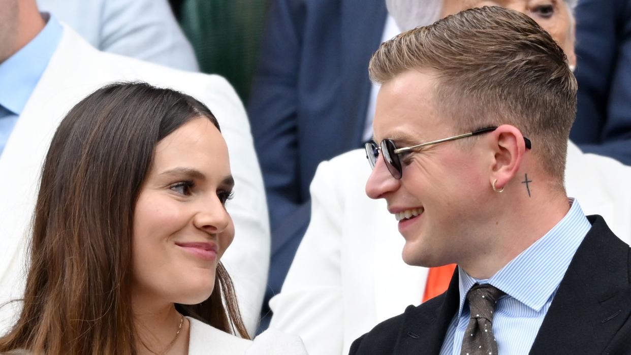 adam peaty and holly ramsay smiling at wimbledon