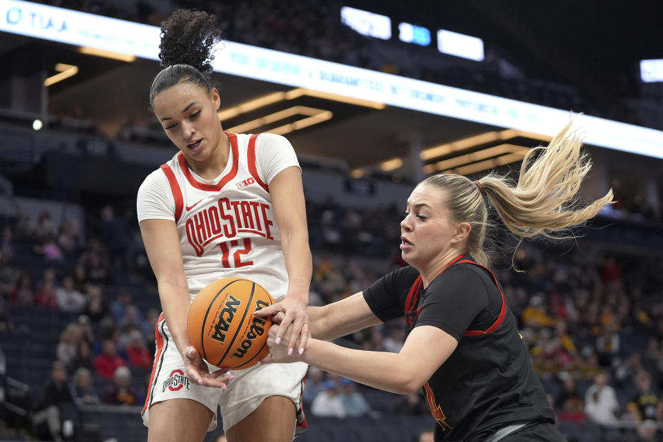 Ohio State guard Celeste Taylor (12) and Maryland guard Bri McDaniel battle for the ball during the first half of an NCAA college basketball game in the quarterfinals at the Big Ten women's tournament Friday, March 8, 2024, in Minneapolis. (AP Photo/Abbie Parr)
