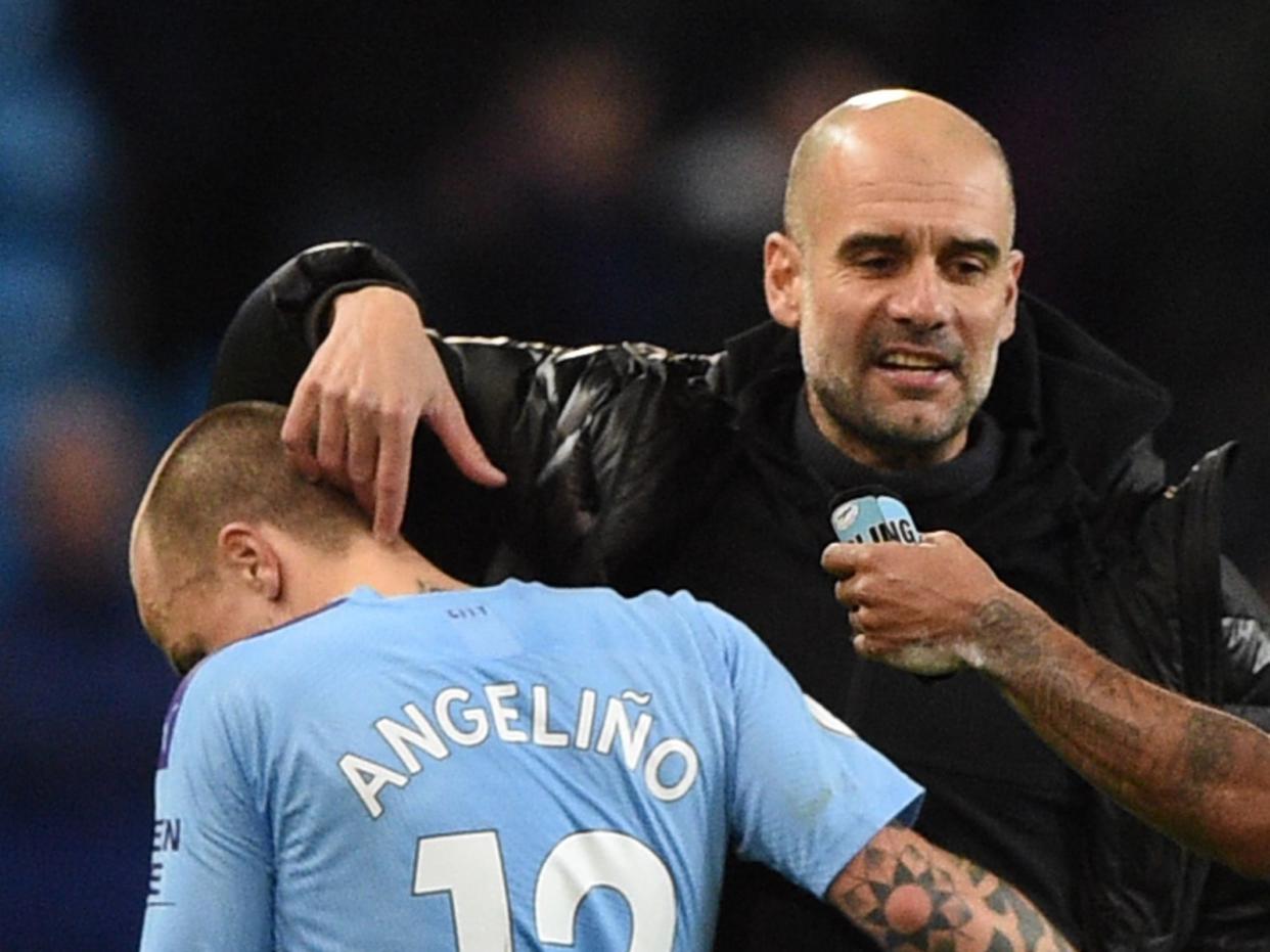 Manchester City manager Pep Guardiola and Angelino (AFP via Getty Images)