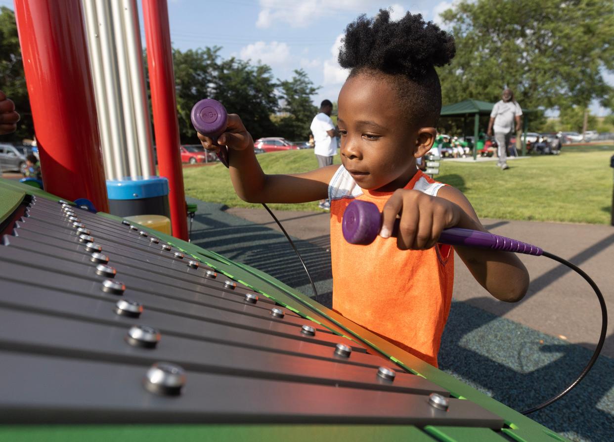 Kaycen Watson, 5, plays on the new Southeast Community Playground in Canton at the Habitat for Humanity dedication celebration.