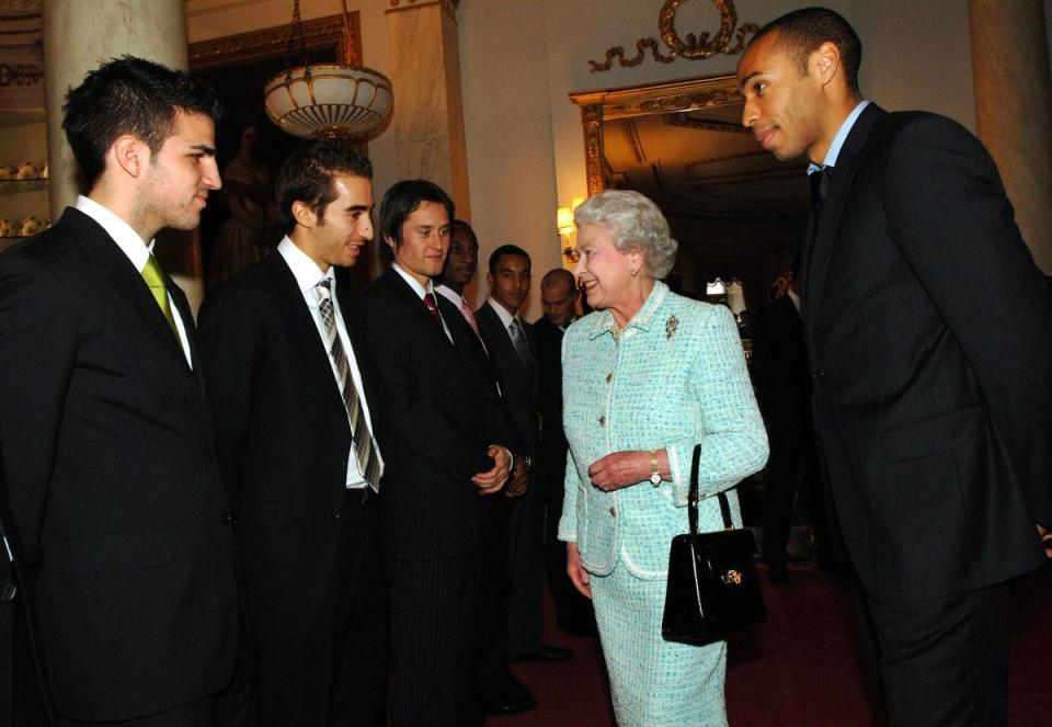Britain’s Queen Elizabeth II meets Arsenal football team members (left to right); Francesc Fabregas, Mathieu Flamini, Tomas Rosicky, Justin Hoyte, Theo Walcott, Freddie Ljungberg and captain Thierry Henry (right) at Buckingham Palace.