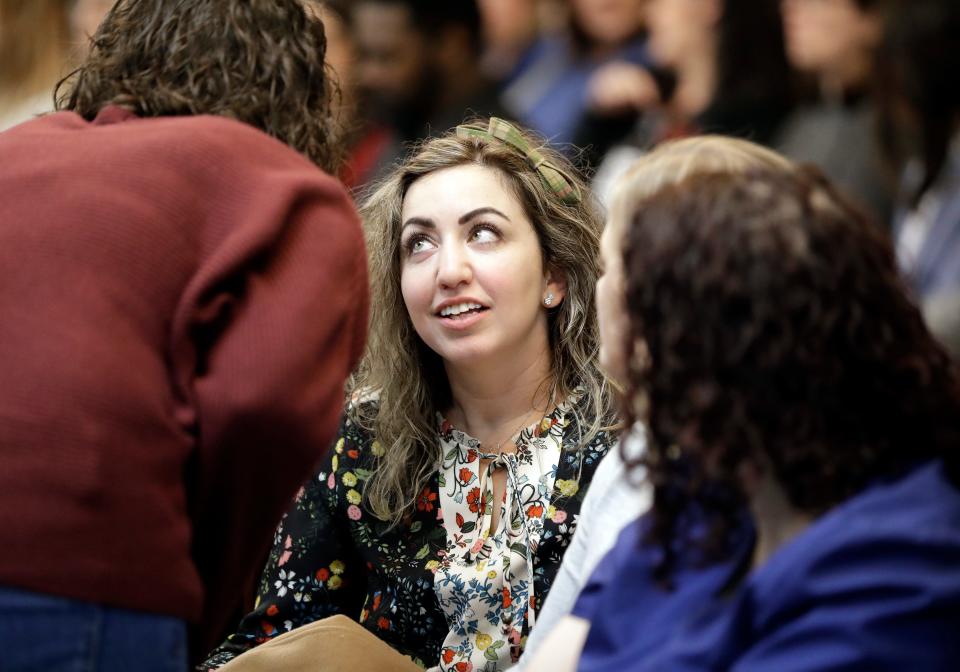 RaDonda Vaught, center, sits with supporters as she waits in court for her hearing to begin Wednesday, Feb. 20, 2019, in Nashville, Tenn. Vaught, a former nurse at Vanderbilt University Medical Center, is charged with reckless homicide after a medication error killed a patient. (AP Photo/Mark Humphrey)