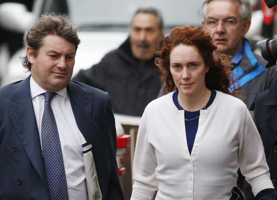 Rebekah Brooks, right, former News International chief executive, and her husband Charlie Brooks, left, arrive at the Central Criminal Court in London where she appears to face charges related to phone hacking, Thursday, Feb. 20, 2014. (AP Photo/Lefteris Pitarakis)