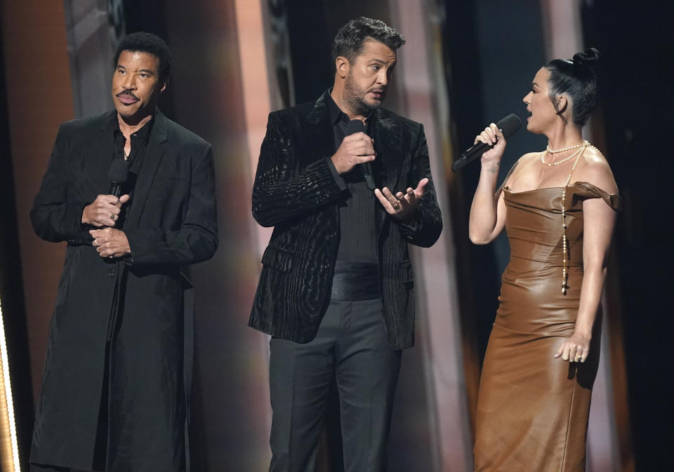 Lionel Richie, from left, Luke Bryan and Katy Perry appear on stage at the 55th annual CMA Awards on Wednesday, Nov. 10, 2021, at the Bridgestone Arena in Nashville, Tenn. (AP Photo/Mark Humphrey)