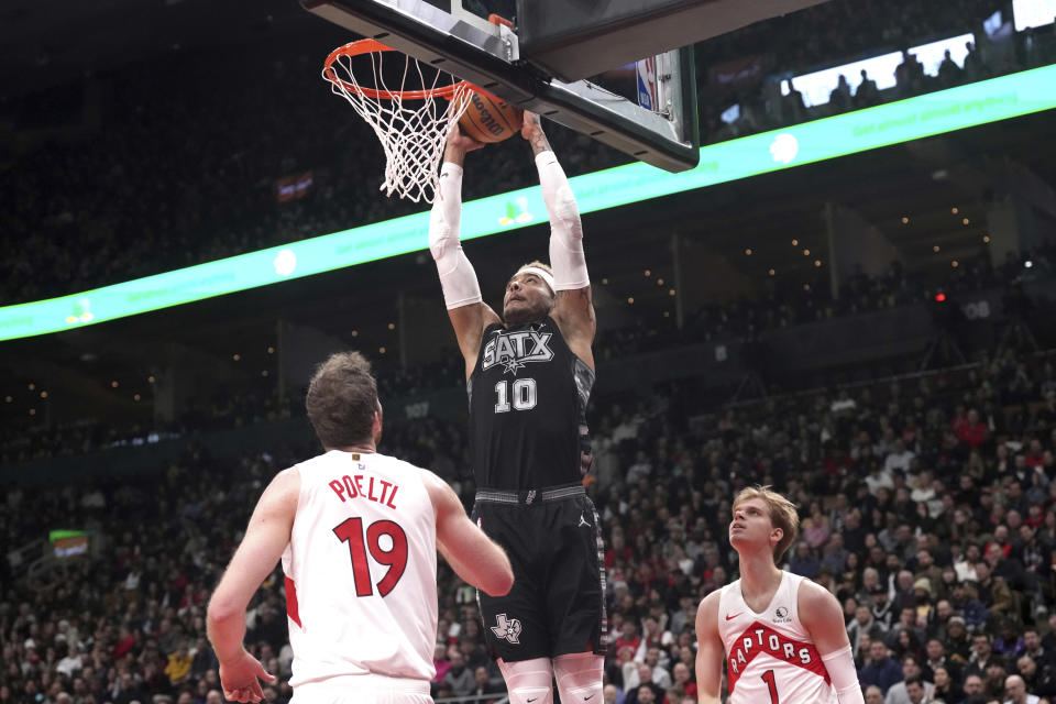 San Antonio Spurs' Jeremy Sochan (10) scores against Toronto Raptors' Jakob Poeltl (19) during first-half NBA basketball game action in Toronto, Monday Feb. 12, 2024. (Chris Young/The Canadian Press via AP)