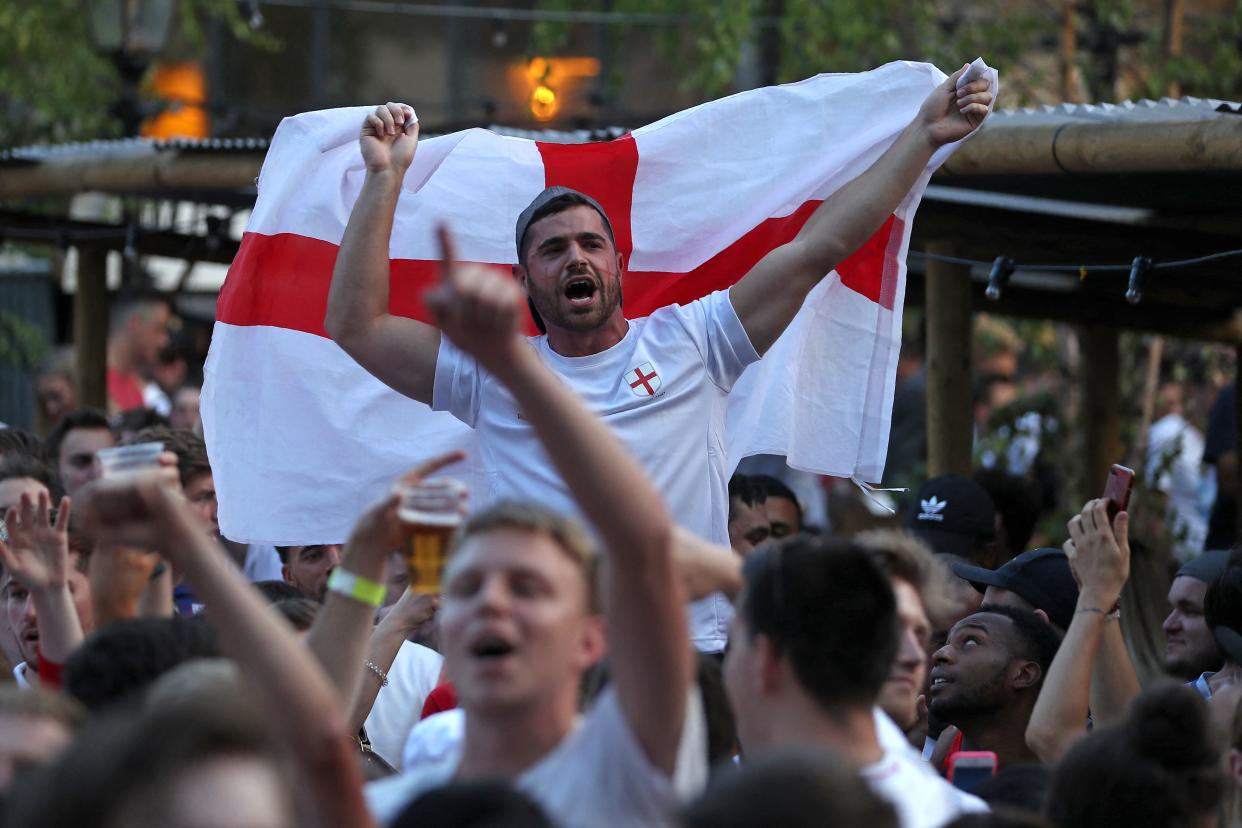 An England supporter holds up a St George's cross flag