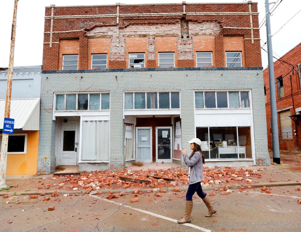 FILE - In this Monday, Nov. 7, 2016 file photo, a television reporter takes video as she walks past a damaged building in Cushing, Okla. caused by an earthquake the night before. Record-setting temblors rocking Oklahoma as the state scrambled to impose new restrictions on the disposal of wastewater in oil and gas production was one of the state's top stories in in 2016. (Jim Beckel The Oklahoman via AP, File)
(Credit: Jim Beckel, AP)