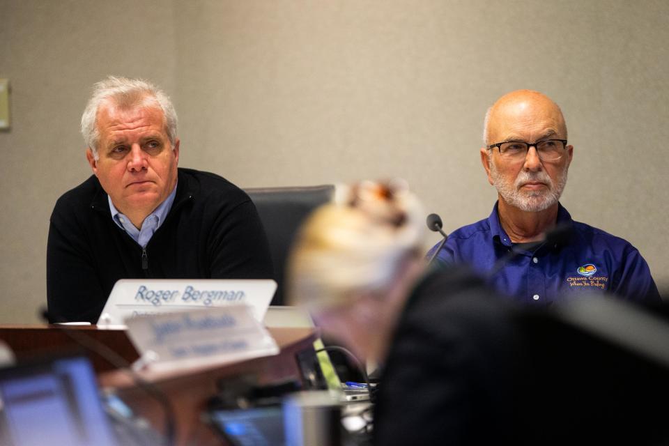 Commissioners Doug Zylstra (left) and Roger Bergman (right) listen to public comment during the board's regular meeting Tuesday, March 14, 2023, in West Olive. 