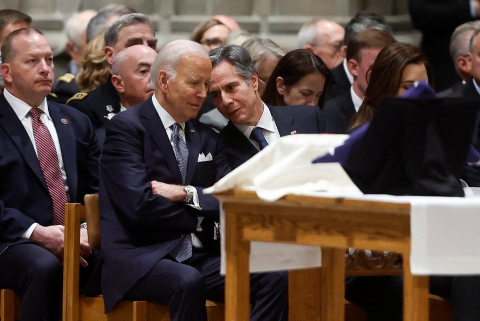 Joe Biden speaks with Secretary of State Antony Blinken as they attend a memorial service for ex-Defence Secretary Ash Carter in Washington (REUTERS)