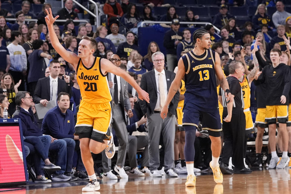 Iowa forward Payton Sandfort (20) reacts after a three-point basket during the second half of an NCAA college basketball game against Michigan , Saturday, Jan. 27, 2024, in Ann Arbor, Mich. (AP Photo/Carlos Osorio)