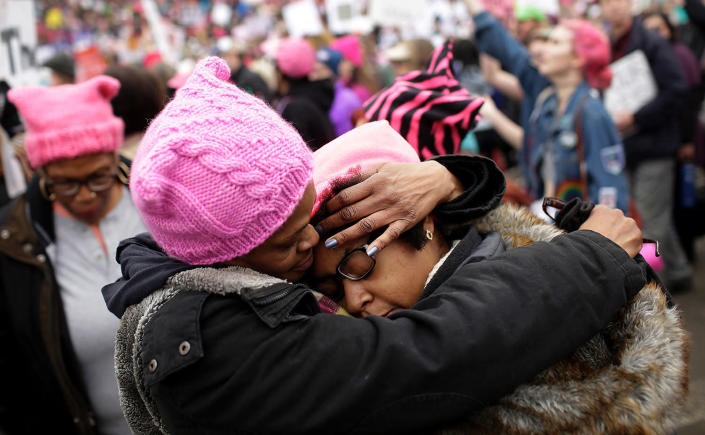 <p>A mother (L) embraces her daughter during the Women’s March on January 21, 2017 in Washington, DC. (JOSHUA LOTT/AFP/Getty Images) </p>