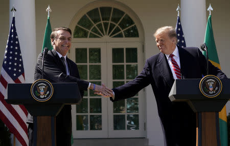 FILE PHOTO: Brazil's President Jair Bolsonaro shakes hands with U.S. President Donald Trump at the conclusion of a joint news conference in the Rose Garden of the White House in Washington, U.S., March 19, 2019. REUTERS/Kevin Lamarque/File Photo