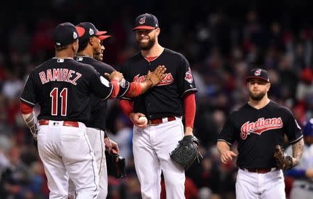 Oct 25, 2016; Cleveland, OH, USA; Cleveland Indians starting pitcher Corey Kluber (middle) is congratulated by teammates as he waits to be relieved in the 7th inning against the Chicago Cubs in game one of the 2016 World Series at Progressive Field. Mandatory Credit: Ken Blaze-USA TODAY Sports