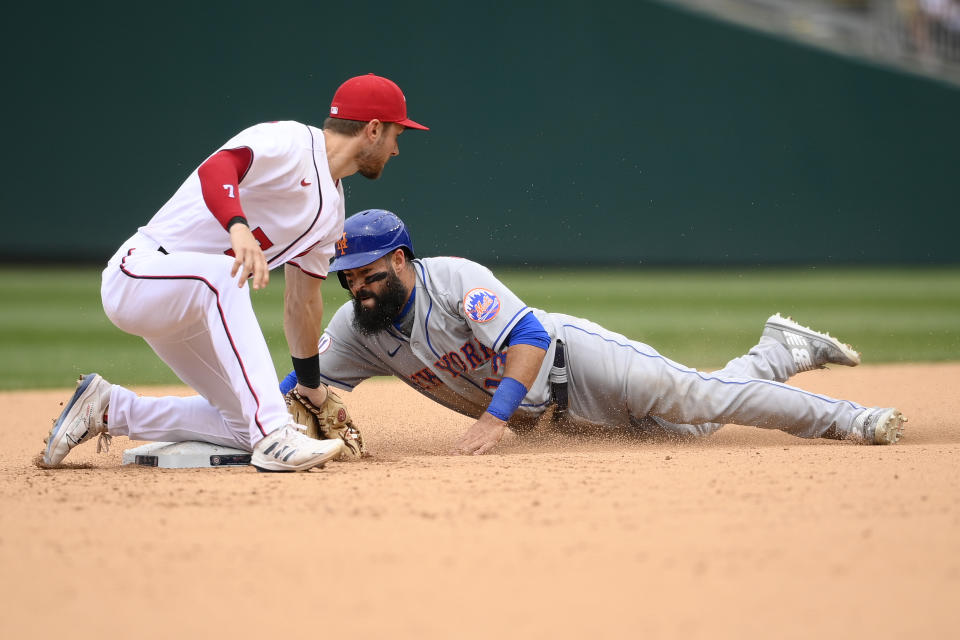 New York Mets' Luis Guillorme, right, is tagged out on a steal attempt by Washington Nationals shortstop Trea Turner, left, during the sixth inning of the first baseball game of a doubleheader, Saturday, June 19, 2021, in Washington. The Mets won 5-1. (AP Photo/Nick Wass)