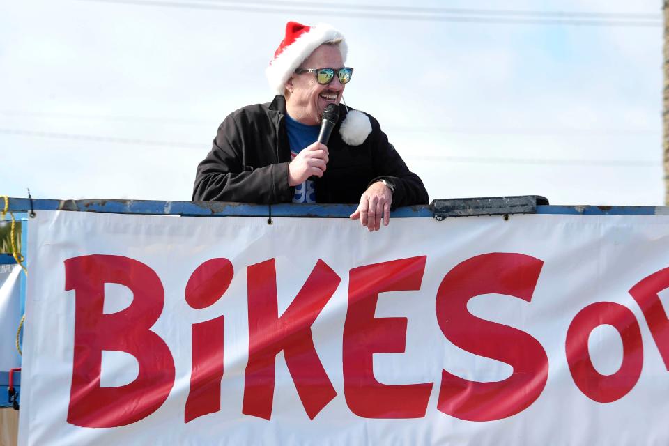 Highway 98 Country radio host Bo Reynolds talks on air from atop a construction lift at Uptown Station at the start of the "Bikes or Bust" bicycle fundraiser on Friday, Dec. 2, 2022. Reynolds will spend 98 hours living on the platform in order encourage listeners to donate bicycles to Emerald Coast Toys for Tots.