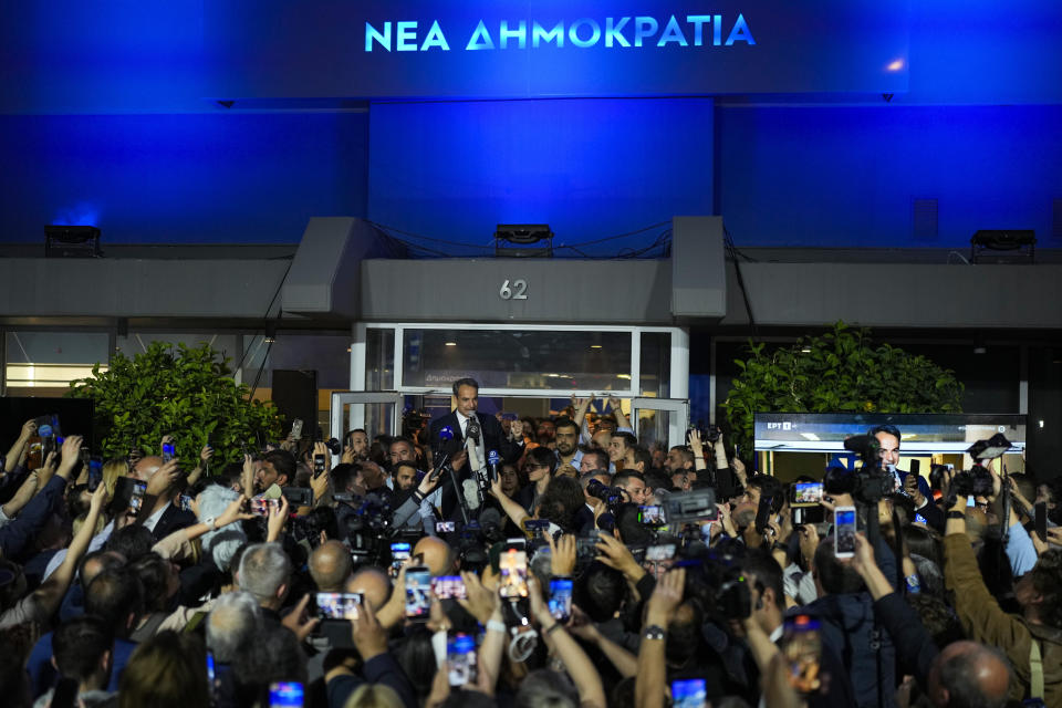 Greece's Prime Minister and leader of New Democracy Kyriakos Mitsotakis, center top, addresses supporters at the headquarters of his party in Athens, Greece, Sunday, May 21, 2023. The conservative party of Greek Prime Minister Kyriakos Mitsotakis has won a landslide election but without enough parliamentary seats to form a government. (AP Photo/Petros Giannakouris)