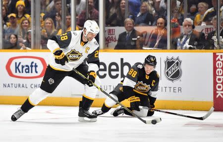 Jan 31, 2016; Nashville, TN, USA; Pacific Division forward John Scott (28) of the Montreal Canadiens skates with the puck after hitting Central Division forward Patrick Kane (88) of the Chicago Blackhawks during the 2016 NHL All Star Game at Bridgestone Arena. Mandatory Credit: Christopher Hanewinckel-USA TODAY Sports