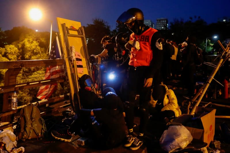 Anti-government protesters scout at a makeshift gate during a standoff with riot police at the Chinese University of Hong Kong, Hong Kong