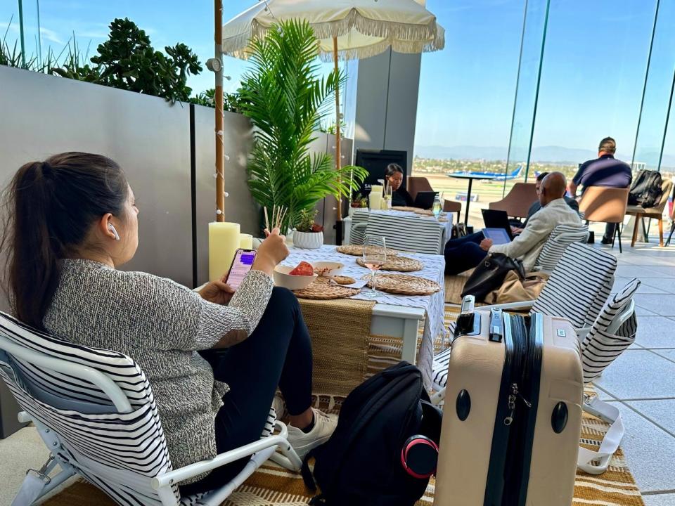 The best place to hang out in the entire Sky Club: The low-slung tables surrounded by even lower-slung beach chairs on the outdoor patio.