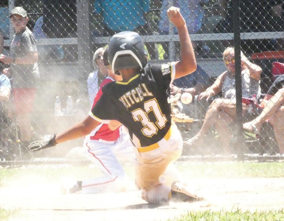 Demare Mitchell, of North Newark's Park National Bank, slides safely into home plate after a wild pitch against North Newark's Dor-Mar Heating during the Farm Division semifinals of the Licking County Shrine Tournament at Mound City Little League complex on Sunday, June 19, 2022. PNB rallied to win 11-10 and plays fellow North Newark foe Med Ben in the championship game at 8 p.m. Tuesday.