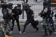 Riot police clash with protesters calling for electoral reforms and a boycott of the Chinese Communist Party in Hong Kong, Sunday, Jan. 19, 2020. Hong Kong has been wracked by often violent anti-government protests since June, although they have diminished considerably in scale following a landslide win by opposition candidates in races for district councilors late last year. (AP Photo/Ng Han Guan)