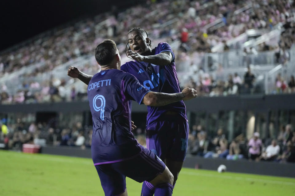 Charlotte FC forward Enzo Copetti (9) celebrates with Charlotte FC forward Kerwin Vargas after Copetti scored his side's first goal against Inter Miami during the first half of an MLS soccer match, Wednesday, Oct. 18, 2023, in Fort Lauderdale, Fla. (AP Photo/Rebecca Blackwell)