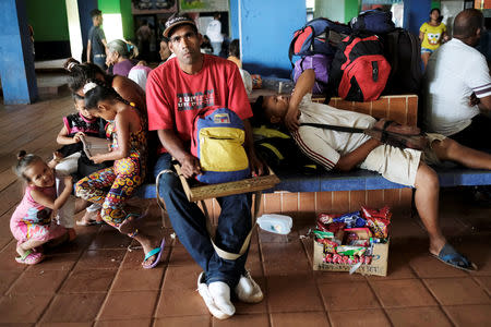 Venezuelans rest next to their belongings at a bus terminal, after being expelled from the Pacaraima border control point by Brazilian civilians, in Santa Elena, Venezuela August 19, 2018. REUTERS/Nacho Doce