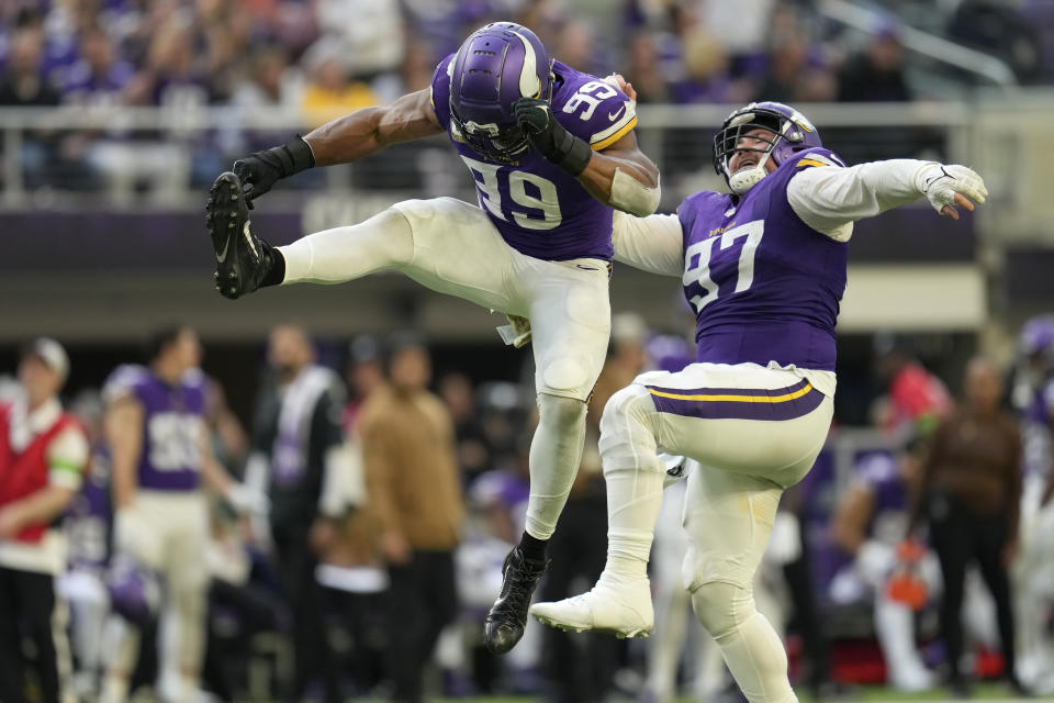 Minnesota Vikings linebacker Danielle Hunter (99) celebrates with defensive tackle Harrison Phillips (97) after sacking New Orleans Saints quarterback Jameis Winston during the second half of an NFL football game Sunday, Nov. 12, 2023, in Minneapolis. (AP Photo/Abbie Parr)